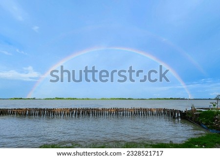 Rainbow, river, fence, nature, cloud, horizon, grass picture for artwork, design, banner, t-shirt, logo and illustration. 
