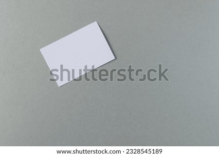 White business card with copy space on grey background. Business, business card, stationery and writing space concept.