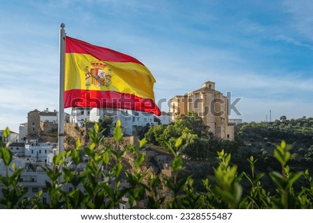 Flag of Spain and Church of la Encarnacion - Setenil de las Bodegas, Andalusia, Spain