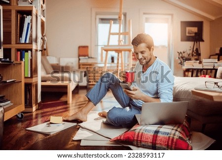 Young man using a smart phone in the morning at home
