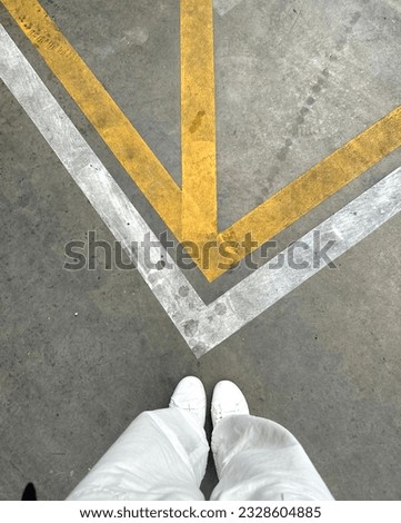 Marking line services, line striping services, car park lines, parking lot, women standing in the parking line, minimal, yellow and white lines, cement background, dirty floor and cracked