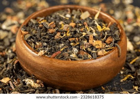 fresh green tea with pieces of fruit and berries, close-up of a large number of dried leaves of green tea close-up