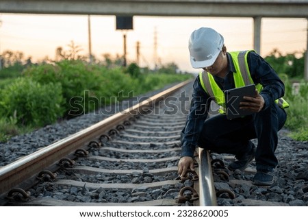 An engineer is sitting and inspecting the railway. Construction workers on the railway. Railway engineer. Infrastructure. Royalty-Free Stock Photo #2328620005