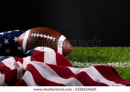 American football ball. American football with American flag. dark background. Team sport concept. copy space. space for text. American football background. America Soccer ball. Royalty-Free Stock Photo #2328624665