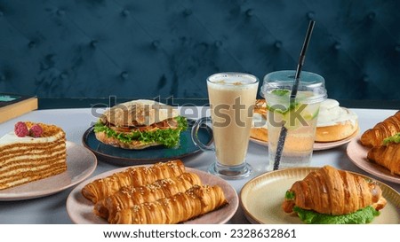 Composition of different dishes with a glass of latte coffee on a blue background. beautiful food photo