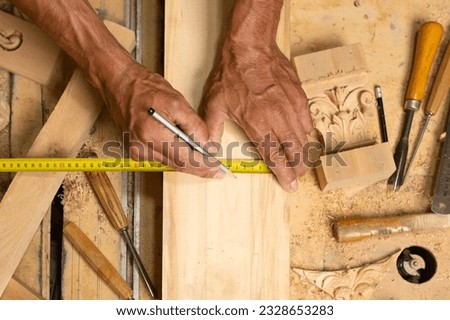 Carpenter working on woodworking tools in carpentry shop. person works in a carpentry shop. woodworker. woodcutting. Royalty-Free Stock Photo #2328653283
