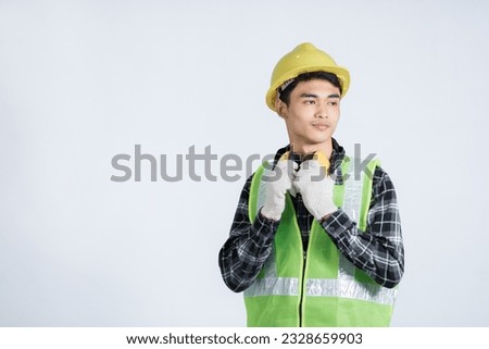 The engineer wears light green protective clothing. wearing a yellow hat wearing white gloves Head slightly to the right, slight smile, half camera angle on a white background. Royalty-Free Stock Photo #2328659903