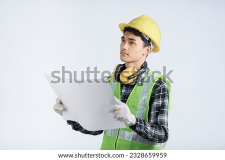 Young Asian engineer in light green protective suit standing wearing yellow hat white gloves yellow headphones holding document happy gesture inspecting work white background design