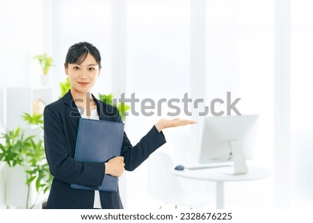 A businesswoman guiding in modern office.  Royalty-Free Stock Photo #2328676225