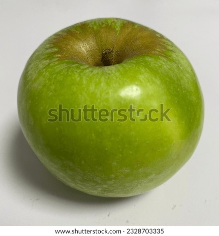 A lush green apple isolated on a white background