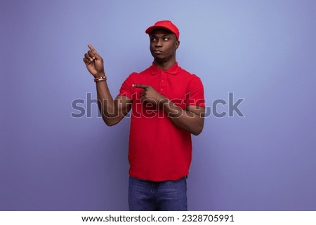 young American man dressed in corporate attire consisting of a baseball cap and a cotton T-shirt