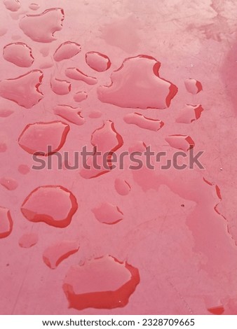 water splash in the red surface Royalty-Free Stock Photo #2328709665