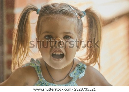charming child fooling around with his face pressed against the glass Royalty-Free Stock Photo #2328735521