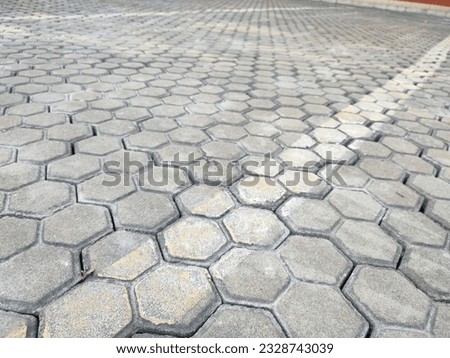 Pavement hexagonal stone background with lines. Hexagonal paving cobble texture laid on city street
