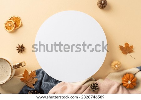 Enjoy the warmth of autumn at home: Top view photo showcasing warm cashmere plaid, hot cocoa and autumnal decorations on beige isolated backdrop. Offers copyspace for text or adverts inside a circle
