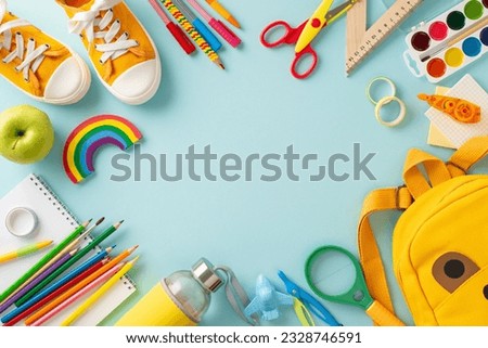 Early education essentials. Top-down view of a yellow child's backpack filled with colorful school supplies and sneakers on a pastel blue isolated backdrop, providing space for text or adverts Royalty-Free Stock Photo #2328746591