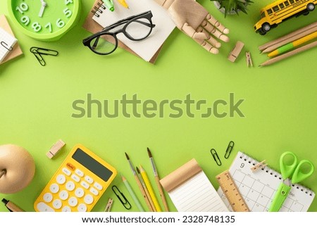Embrace the essence of educational journey with this top-view shot displaying schedule, planner and array of stationery on isolated green background. Utilize copy-space for text or promotional content