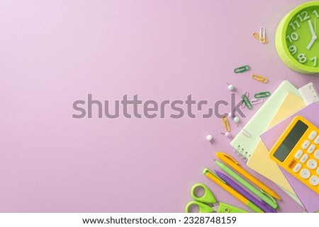 Explore the world of learning through this creative above view picture showcasing notepads, calculator and other school supplies on an isolated light purple backdrop. Perfect for text or advertising