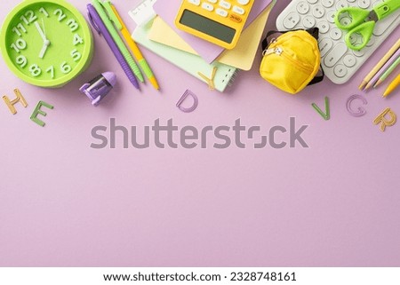 Embrace the convenience of online learning with this top-down photo featuring a keyboard, planner, stationery and abcs figures on pastel purple background. Ample copy-space available for text or ads