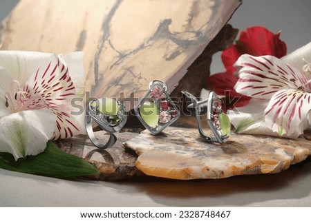 Elegant jewelry set. Jewellery set with gemstones. Jewelry accessories collage. Product still life concept. Ring, necklace and earrings.