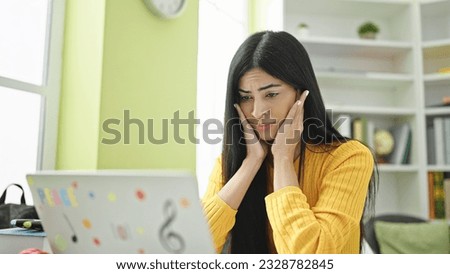 Young beautiful hispanic woman student tired leaning on the desk at library university