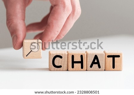 In the man's hand are cubes with the inscription - CHAT.