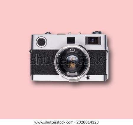 vintage old film camera on pink background with shadow