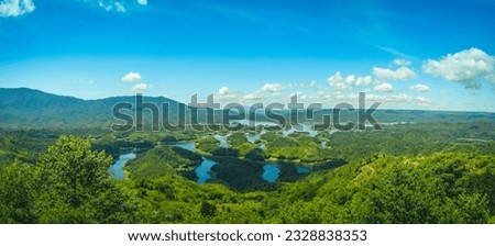 Aerial view of Morning at the Ta Dung lake or Dong Nai 3 lake with green hills and mountains. This is the reservoir for hydro power in Dak Nong province, Vietnam. Travel concept. Royalty-Free Stock Photo #2328838353