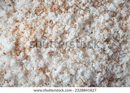 freshly grated coconut, aka coconut shreds or scrapes, small pieces finely grated or shredded, ingredient commonly used in various cuisines, taken straight from above in full frame food background Royalty-Free Stock Photo #2328841827