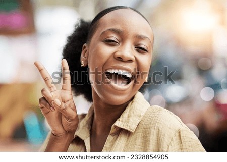 Portrait, smile and peace with an excited black woman on a blurred background posing for a photograph. Face, emoji and profile picture with a happy young female comic looking playful while laughing