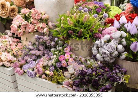 Floristry. Compositions of artificial flowers in a gardening store. Royalty-Free Stock Photo #2328855053