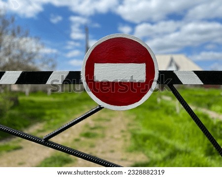 STOP sign - on striped iron beam on green summer background