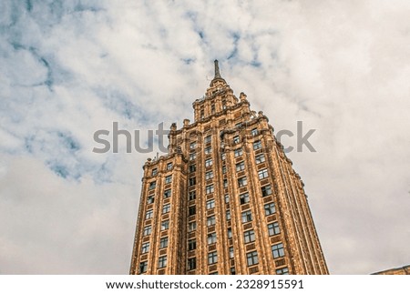 Low angle view of buildings against cloudy sky 