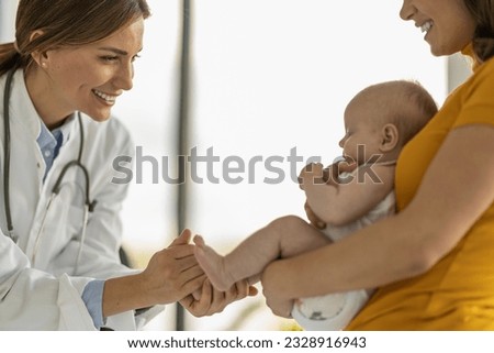 Mother with her cute baby visiting pediatrician in clinic.Pediatrician with baby in her doctor office. Royalty-Free Stock Photo #2328916943