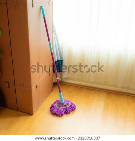Magic Mop in color purple with blue  retail in a habitation