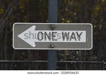 A one way sign telling people that traffic only flows in one direction, to the left