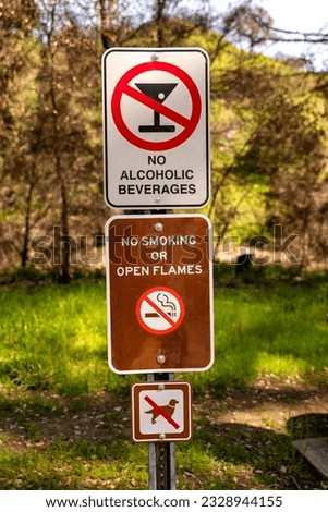 No alcohol, no fire, no dogs sign in a park