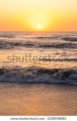 Sunrise over the sea. Pastel shades. Beautiful landscape. Sandy beach of the ocean. Sunset sky.