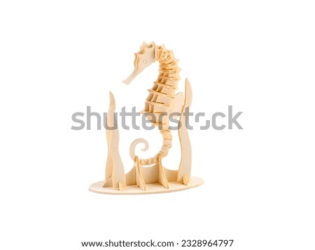 Miniature decorative seahorse animal made of wood on a white background