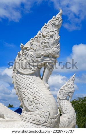 Naga dragon at the bottom of the stairs leading to the Great Buddha of Phuket aka Ming Mongkol Buddha, a white marble statue sitting on top of a hill on Phuket island, Thailand