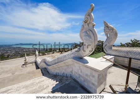 Naga dragon at the top of the stairs leading to the Great Buddha of Phuket aka Ming Mongkol Buddha, a white marble statue sitting on top of a hill on Phuket island, Thailand