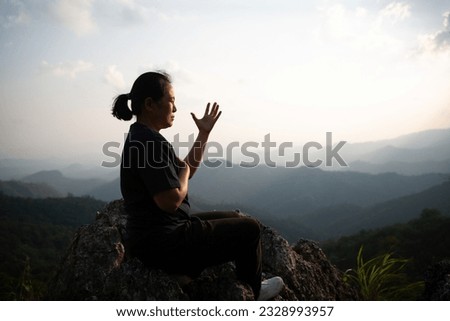 Woman praying to god, posing asian women, girl adult fashionable model, feeling moments, enjoying, happiness on top mountain. Female christian worshipper.