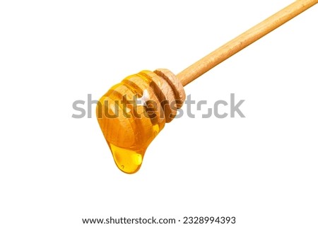 Honey dripping from honey dipper isolated on white background. Thick honey dipping from the wooden honey spoon. Healthy food and diet concept Royalty-Free Stock Photo #2328994393