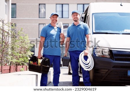 Technician Electrician Man With Cable Near Van Royalty-Free Stock Photo #2329004619