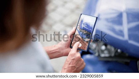 Person Taking Picture Of Damaged Car On Mobile Phone