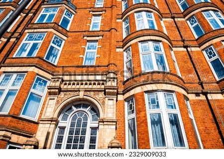 Residential apartment flats house building entrance in Gothic revival style architecture in city of Westminster, London UK on sunny summer day Royalty-Free Stock Photo #2329009033