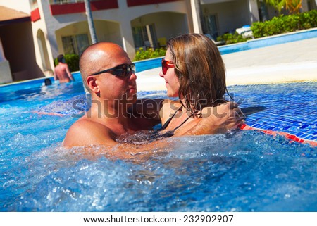 Loving happy couple in hot-tub. Summer vacation.