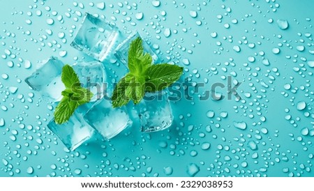 Top view photo of mint leaves ice cubes and water drops on isolated pastel blue background