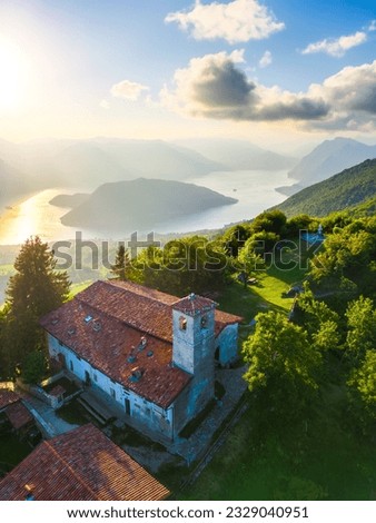 Vertical aerial view of lake Lago d'Iseo and Montisola from Santa Maria del Giogo during summer sunset. Sulzano, Iseo, Lombady, Italy Royalty-Free Stock Photo #2329040951
