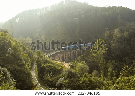 Train crosses Demodara nine arch bridge. Sri Lanka. Aerial background image with copy space Royalty-Free Stock Photo #2329046185